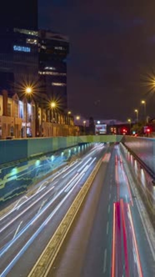 Timelapse of Car Trails in Underpass in Residential Area at Night Big City Life Cars and Buses Run