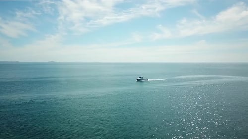 Aerial drone 4k cinematic footage. Flying above speed boat on the blue sea. sideways over fast movin