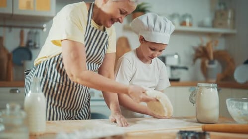 Grandmother and Child Baking Cookies Together in Kitchen