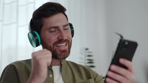 Man Enjoying Music on Phone With Headphones