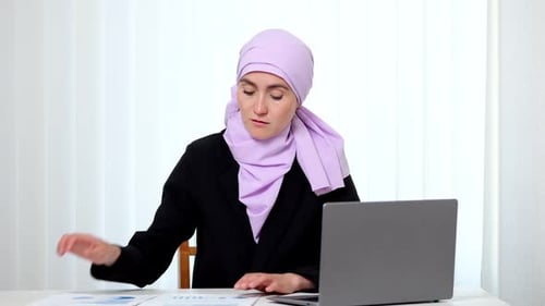 Muslim Lady Entrepreneur Types Analysis of Documents on Laptop