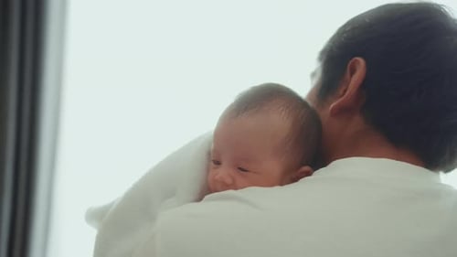 Young father with a Cute new born baby.