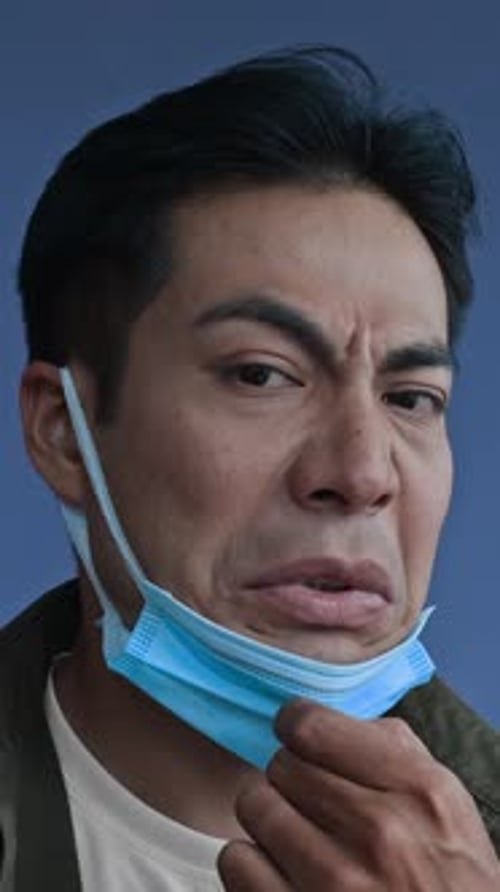 Person Putting on a Light Blue Face Mask