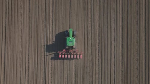 Tractor cultivating striped field