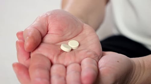 Palms of Mature Woman with Painkiller Pills From Headache
