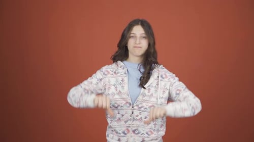 Young Adult Demonstrates Thumbs Up and Thumbs Down