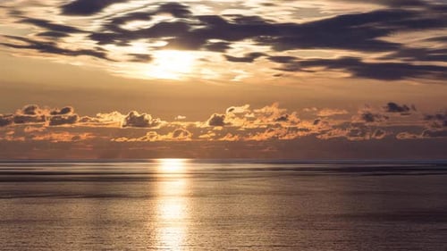 Romantic colorful sunset at the sea. Against the background of the sea, the sun goes down