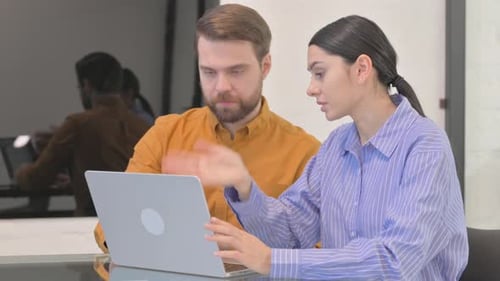 Business People Working on Laptop in Office