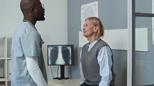 Doctor Checking Patient in Clinic Exam Room