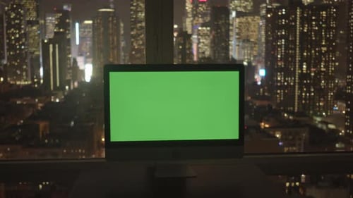 Monitor with Green Screen Overlooking City at Night