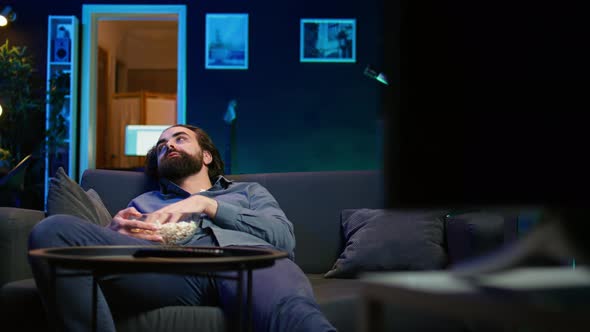 Bored Man at Home Slacking Off Entertaining Himself By Throwing Popcorn ...