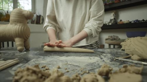 Closeup of a Ceramist's Hands Kneading Clay in the Workshop