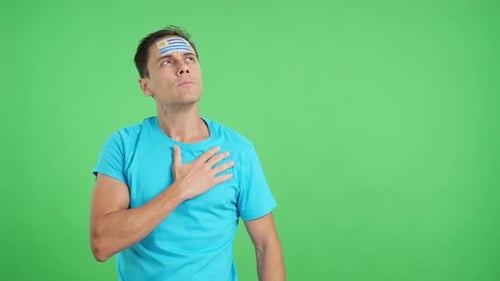Man Listening to the Uruguay National Anthem with Solemnity