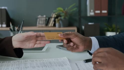 Credit Card Exchanged at Business Meeting
