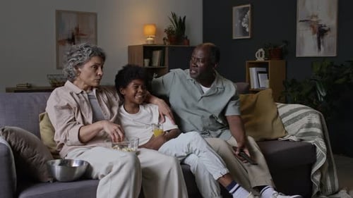 Three Family Members Watch Television Together