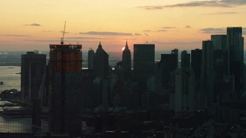 Manhattan skyline shimmers as twilight paints New York City golden with sunset light