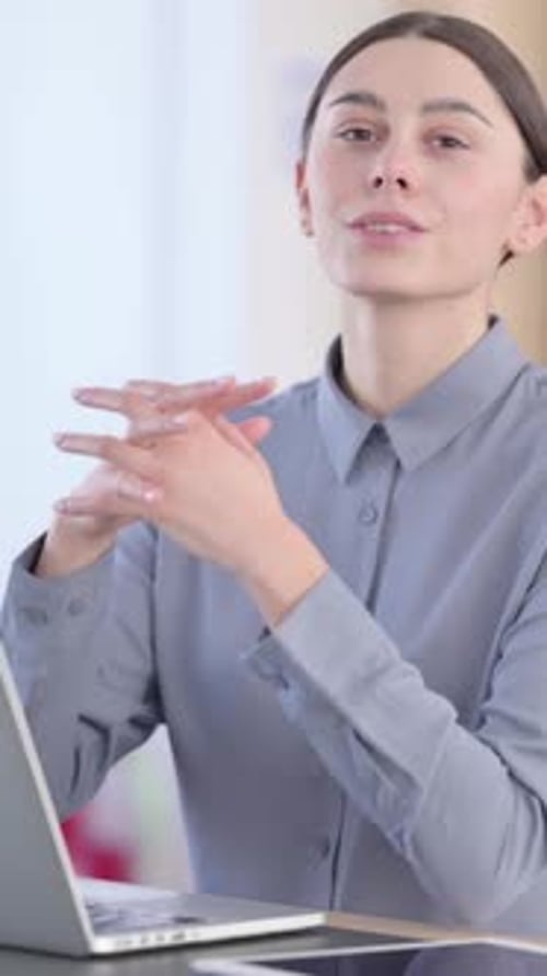 Woman Smiling at Computer Screen in Office