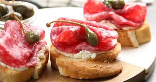 Gourmet Appetizer: Crostini Topped with Salami and Herbs