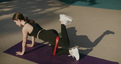 Woman Exercising Outdoors with Resistance Band