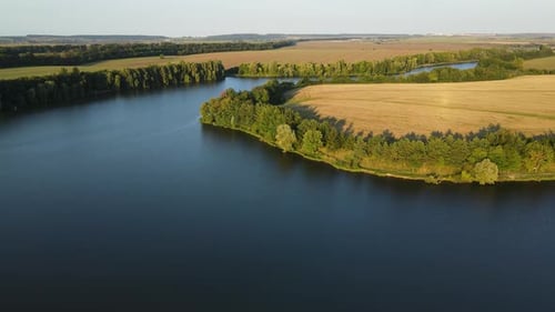 Aerial Panoramic View on the Wide River Among Agricultural Fields