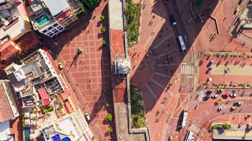 Slow motion top down aerial view of cartagena's clock tower plaza, showcasing the bustling city life