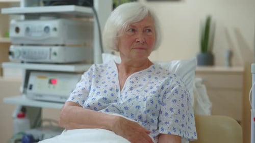 Elderly Happy Caucasian Woman Grandmother Lying in Hospital Bed Recovering Illness Receiving Support