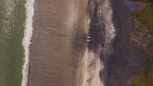 Top Down Drone Approaching Vehicle on Beach