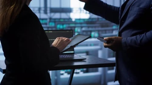 Coworkers in Data Center Replacing Storage Rigs Parts to Improve Performance