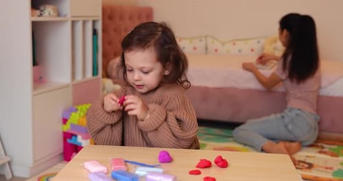 Child Plays with Clay at Home
