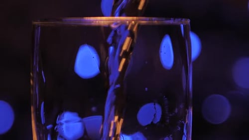 Bubbles sparkle in champagne glasses and spin slowly. Bubbles rise beautifully up in glasses. Blurre