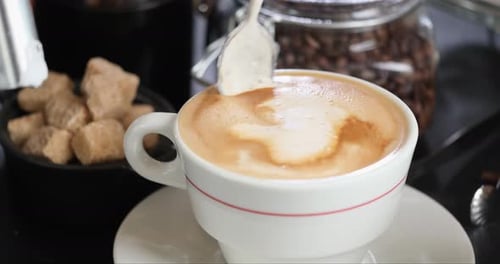 Close Up of Latte Being Stirred