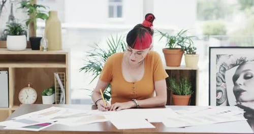 4k video footage of a young businesswoman going over paperwork in a modern office