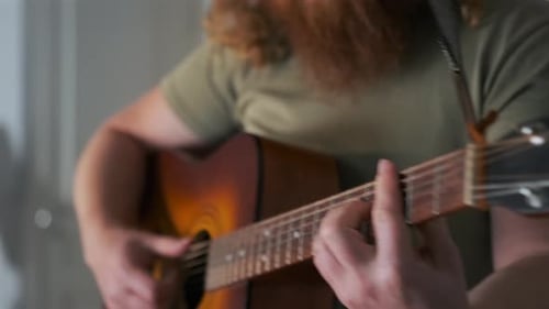 Man Playing Acoustic Guitar Close Up Indoors