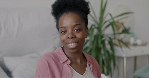 Smiling Woman Posing in Natural Light Indoors