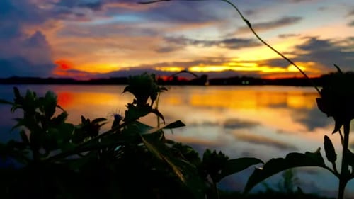 The beautiful sunset over the calm waters of the lake makes for a perfect view