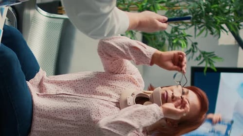 Woman in Neck Brace Consults with Doctor