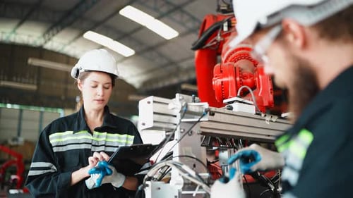 Engineer specialist female and technician maintenance inspect robot arm components.