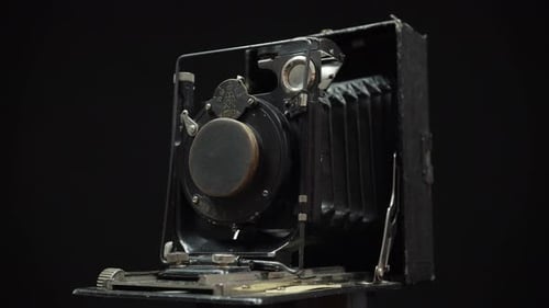 Rotating Vintage Camera on Black Background