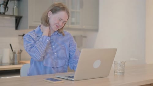 Woman Working at Home Experiencing Neck Pain