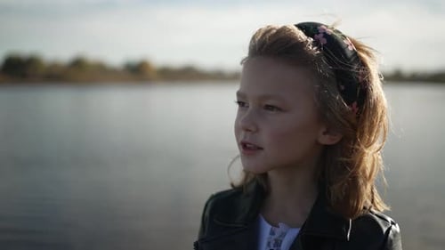 Young Girl with Headband Enjoys Lake View