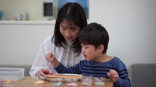 Mother and Child Painting Together at Home