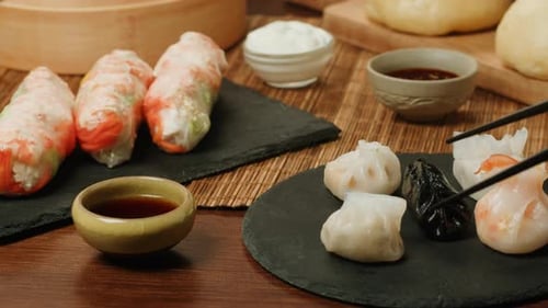 Dimsun Gyoza Dumplings and Spring Rolls on Table Closeup Food Delivery Homemade Dishes