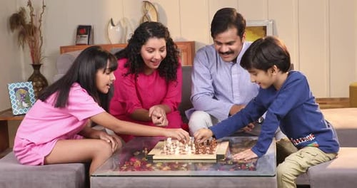 Happy Family Playing Chess Together at Home