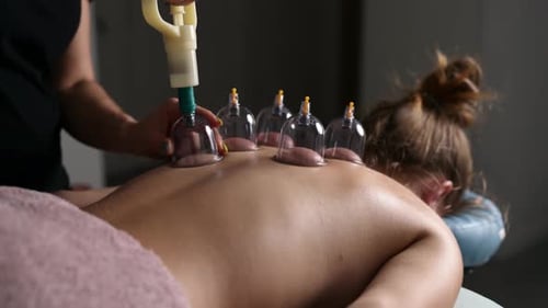 Massage Therapist Doing Back Vacuum Massage With Cups In Spa