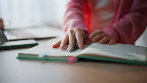Woman Writes and Types in Bright Home Office
