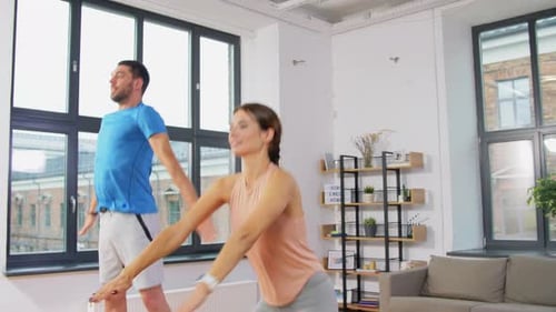 Sport, Fitness, Lifestyle and People Concept - Smiling Man and Woman Exercising