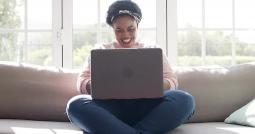 Smiling Woman Working On Laptop At Home