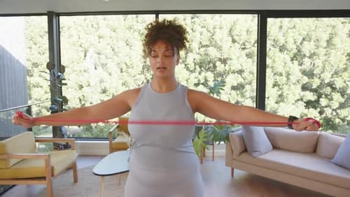 Woman Working Out with Resistance Band Indoors
