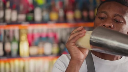 Close Up Bartender Shakes a Cocktail in Shaker