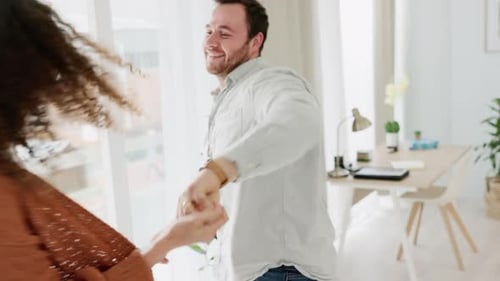 Happy Couple Dancing Together in Bright Home